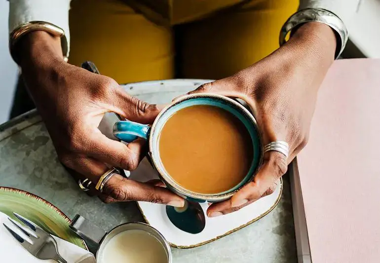 person Holding Coffee Cup Top View 1213479257 770x533 1 jpg